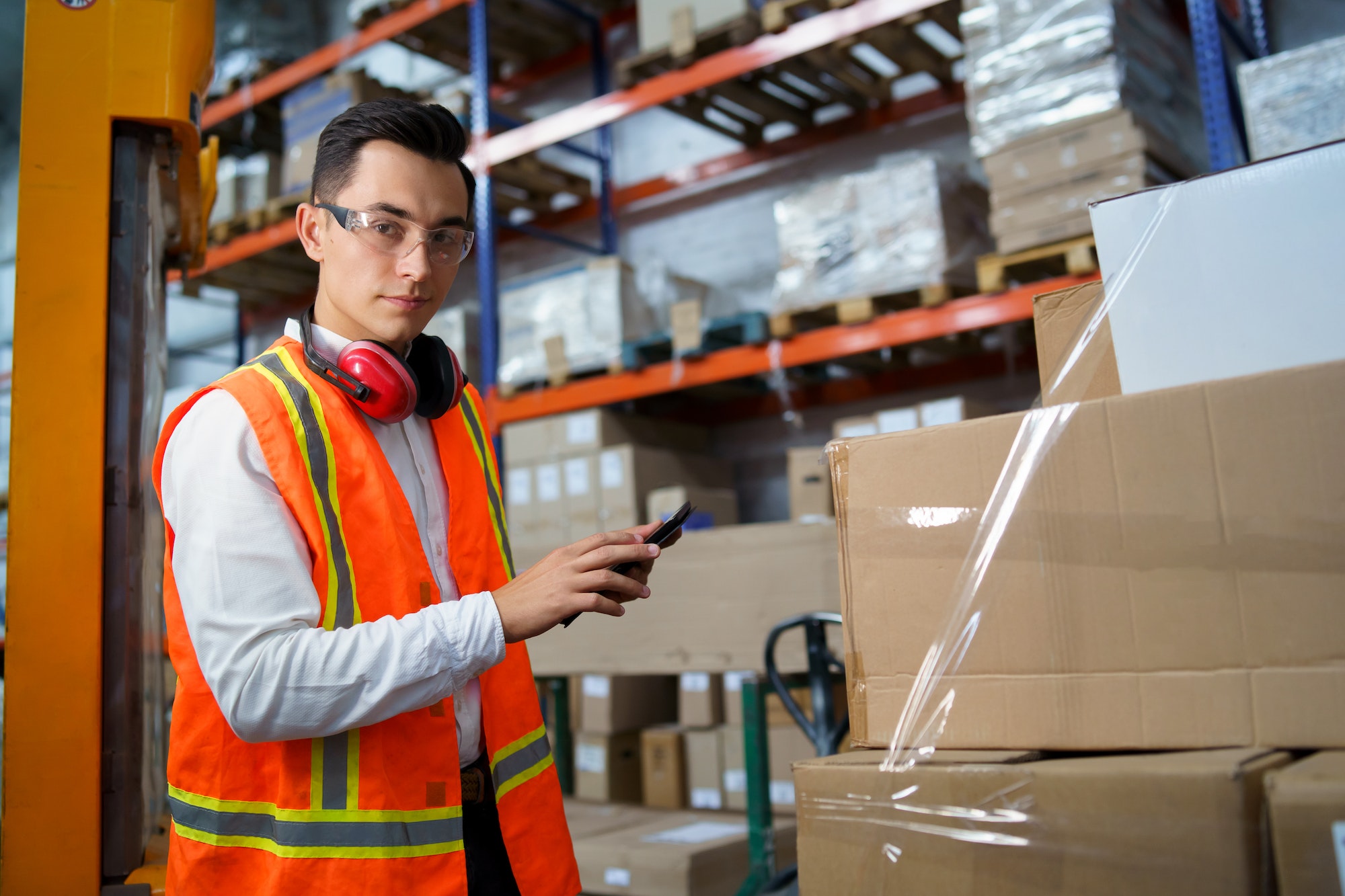 Portrait of a young worker of a logistics warehouse